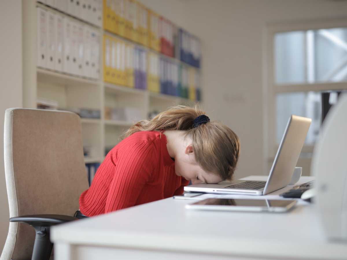 Woman asleep on her computer keyboard